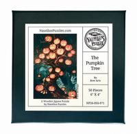 A framed wooden jigsaw puzzle package front for 'The Pumpkin Tree' by Nautilus Puzzles, featuring a black frame, white label area, and a central artwork of glowing jack-o'-lanterns on a tree.